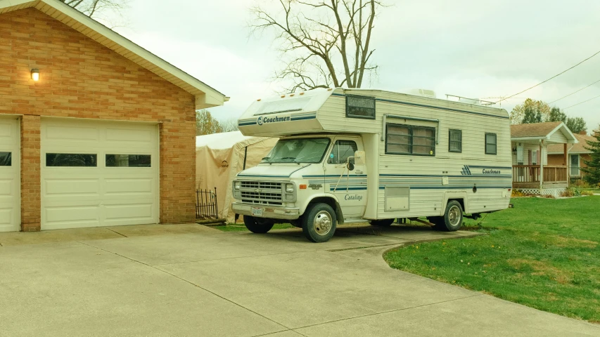 the truck and camper are parked outside of a house