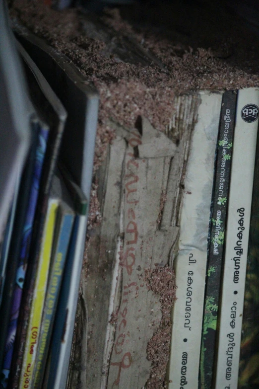 several books are sitting on a shelf by the walls