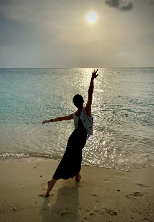 a woman is on a beach in front of the water