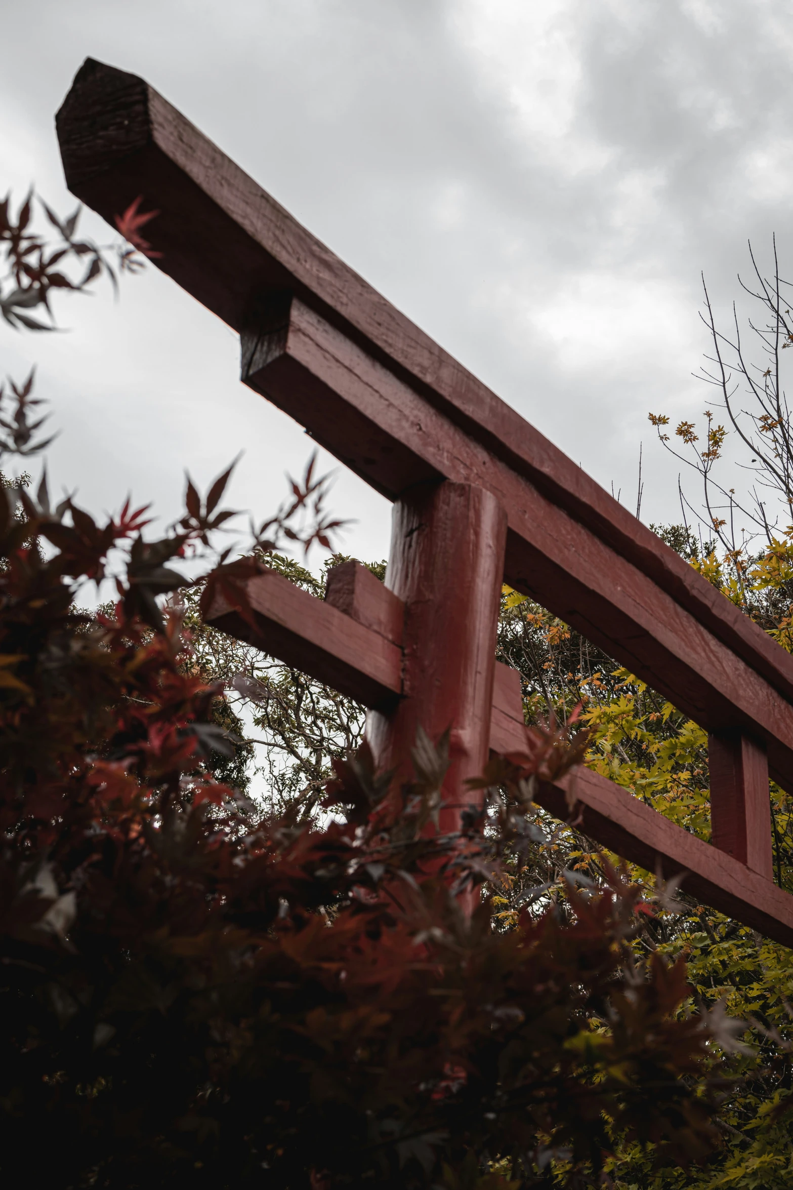 a wood fence next to some trees with a clock on the top