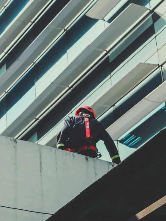 a man in a red and black jacket with a red helmet is riding on his skateboard