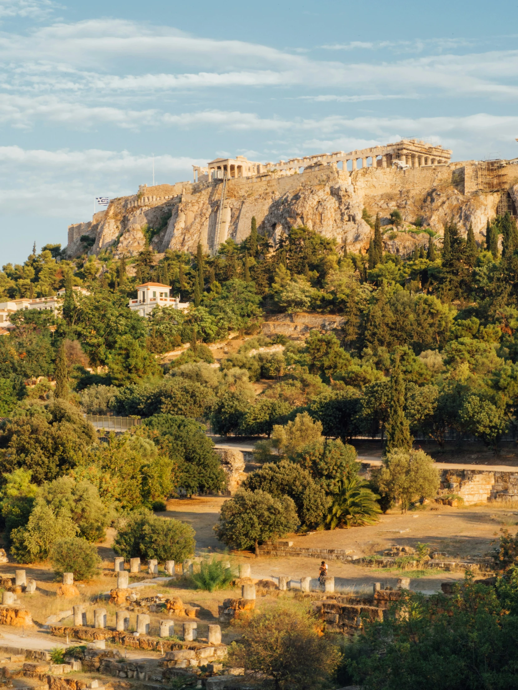 a rocky landscape filled with trees and stone buildings