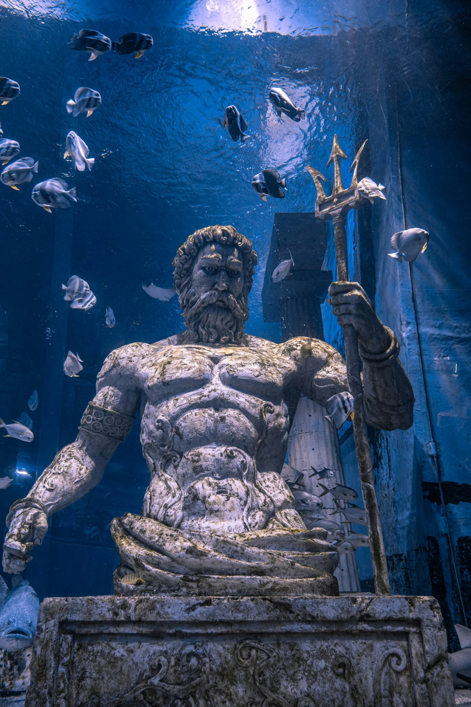 the statue of an old god surrounded by sea creatures