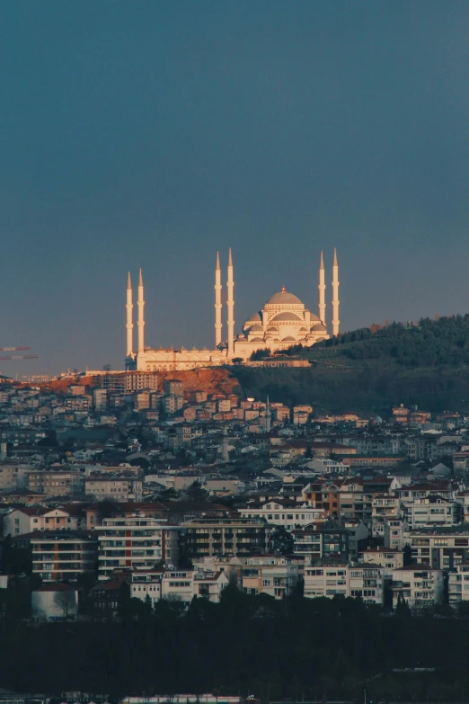 a city with many buildings on it near hills