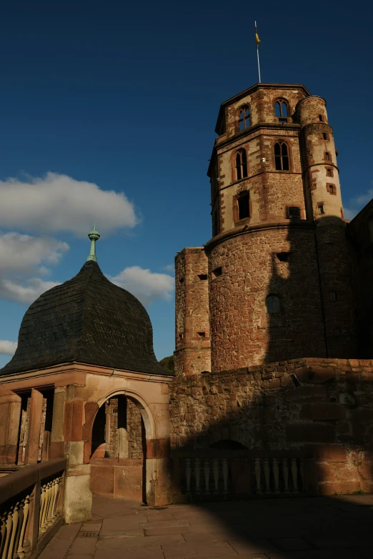 a very tall tower sitting in the middle of a stone area