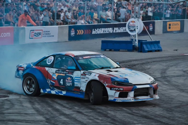 a drift car burns on the track at an event