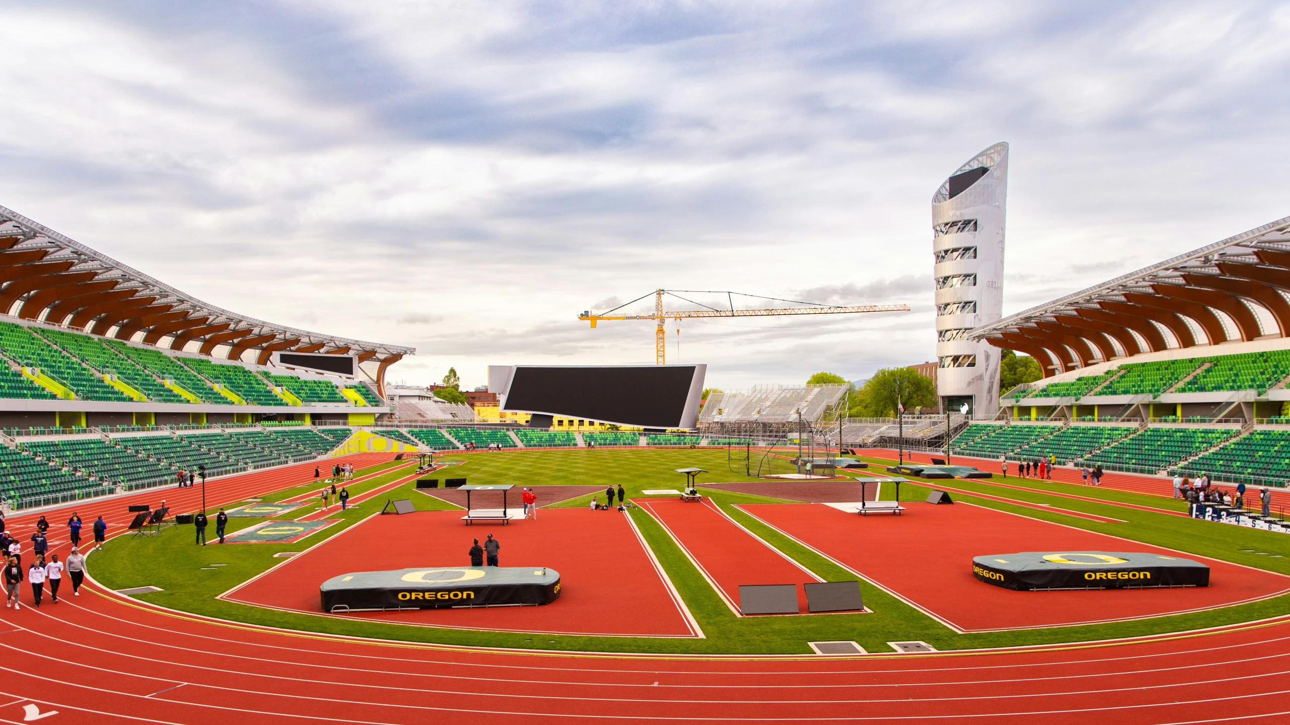 the stadium, with many empty seats and grass in front of it