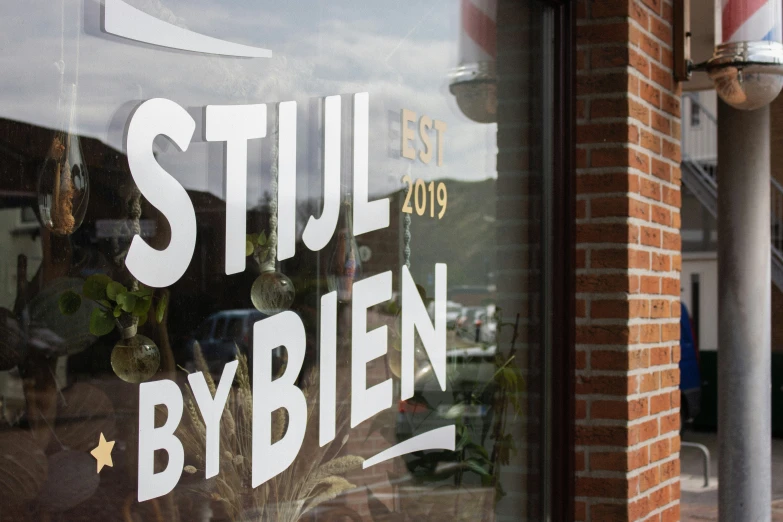 the window glass of a business that says still by bien