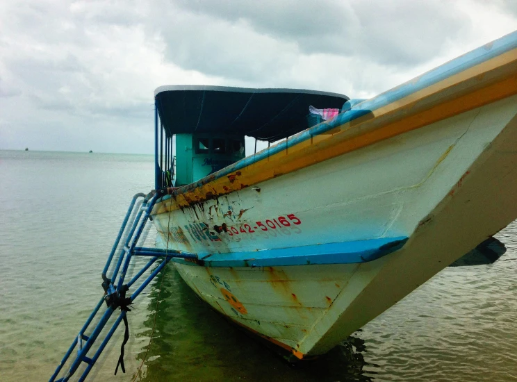 a boat sitting on top of the shore in water