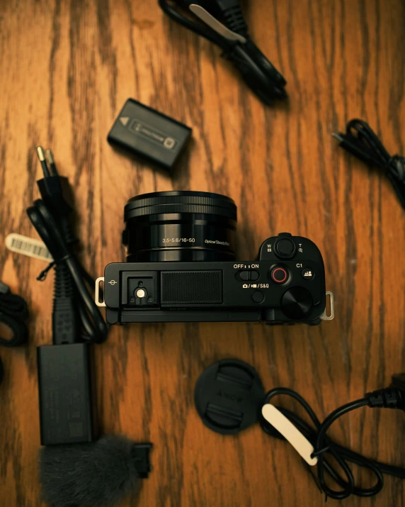 a camera sitting on a table with many electrical wires attached to the back