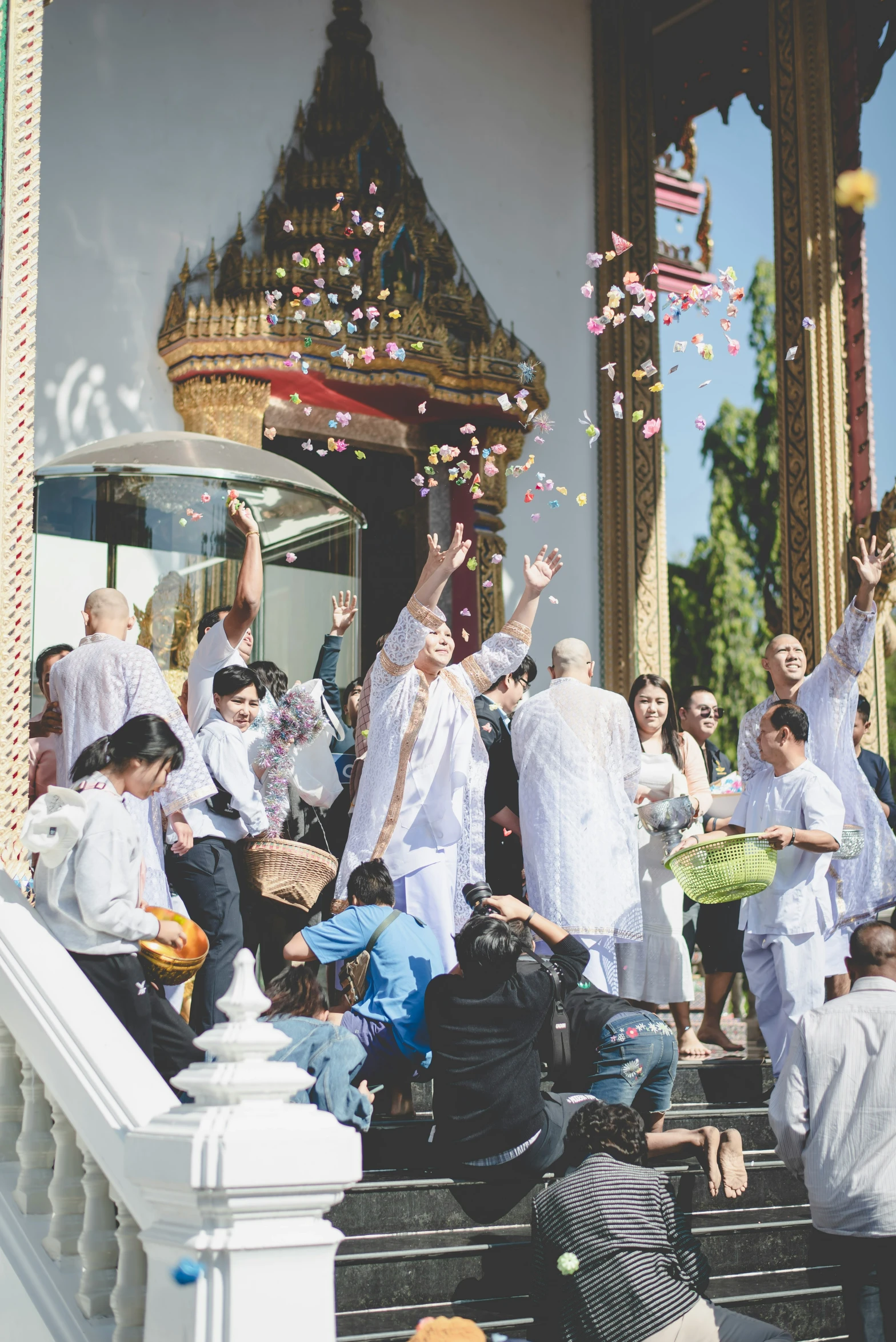 a group of people celeting and throwing confetti