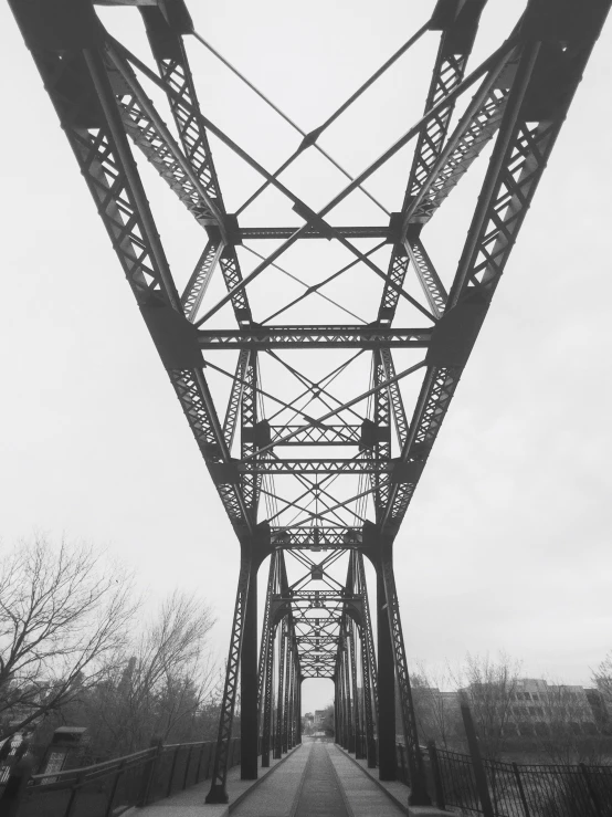 a black and white picture of a metal bridge