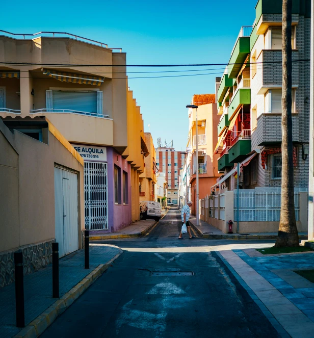 an empty street lined with colorful houses on either side