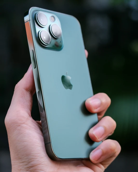 a person holding an apple iphone in their hand