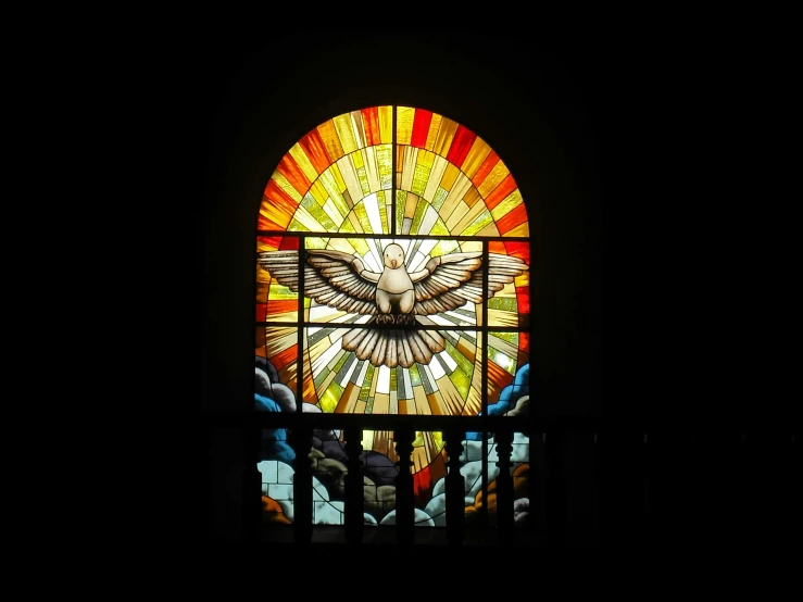 a large stained glass window that is inside of a church