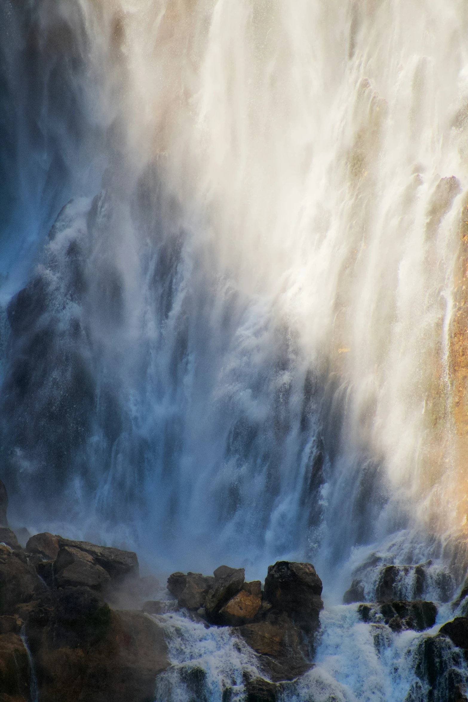 the water is moving down the waterfall