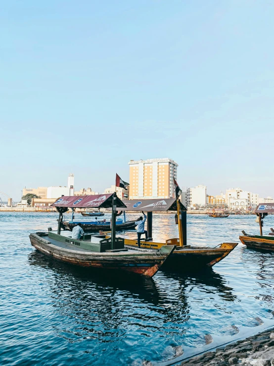 three boats on the river waiting for passengers