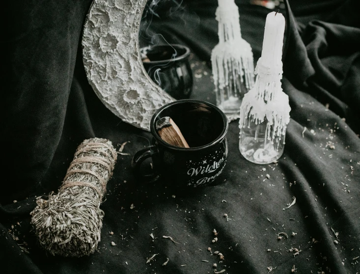 a jar, spoons, and a broom are on the table