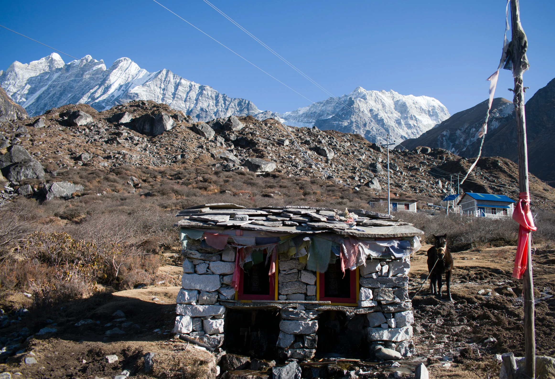 there is a stone shack in the mountains