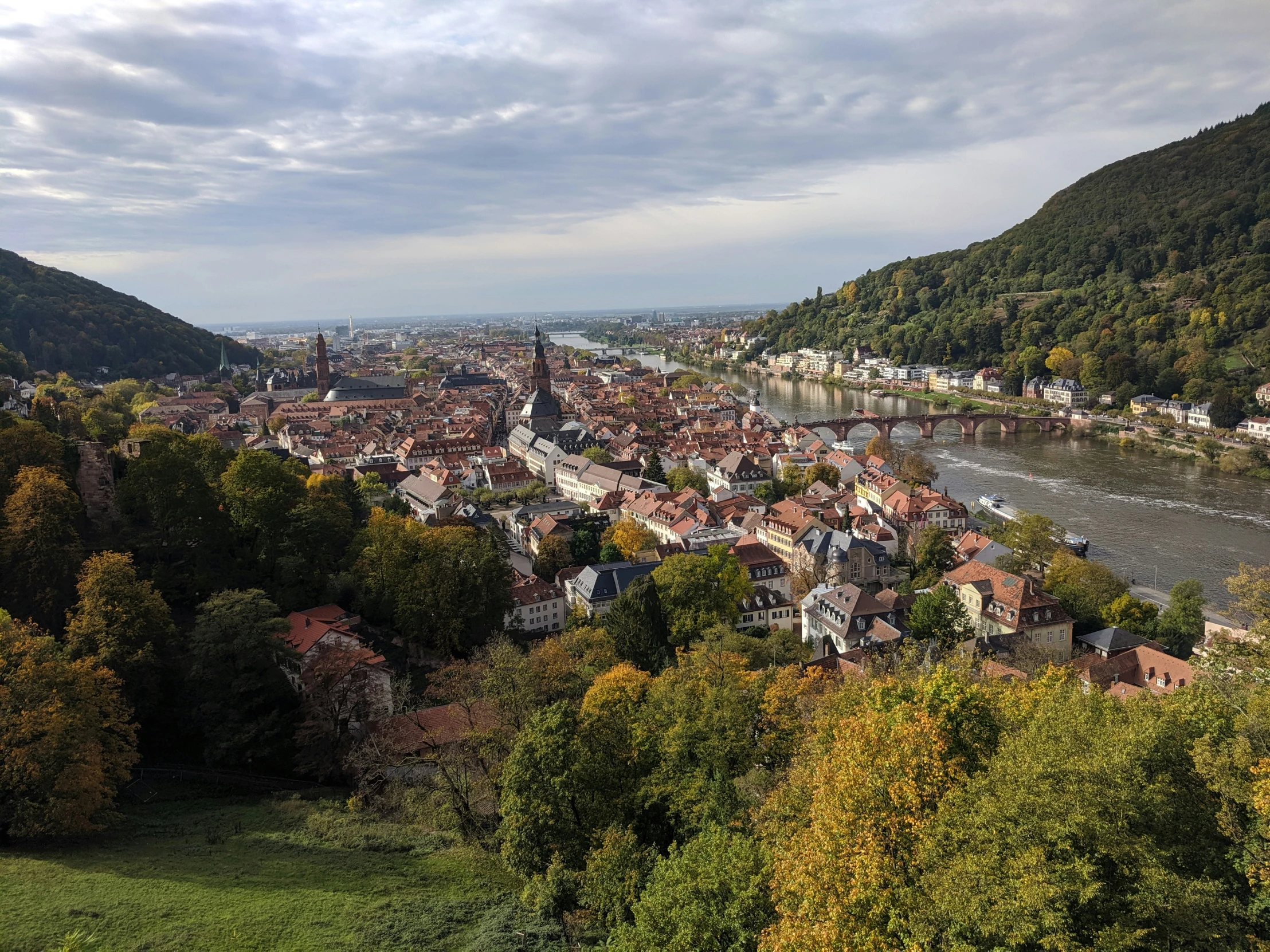 a bird - eye view of a small village nestled next to a river