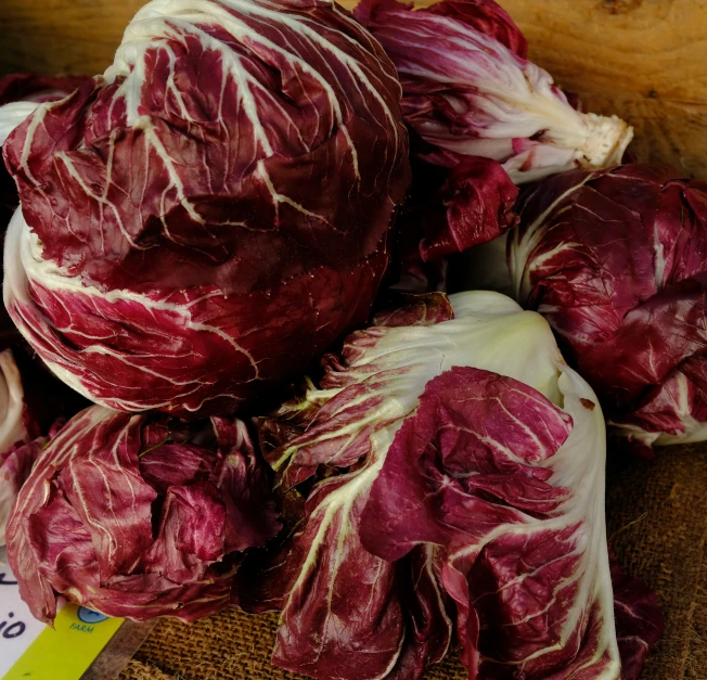 the red lettuce is laying on top of the table