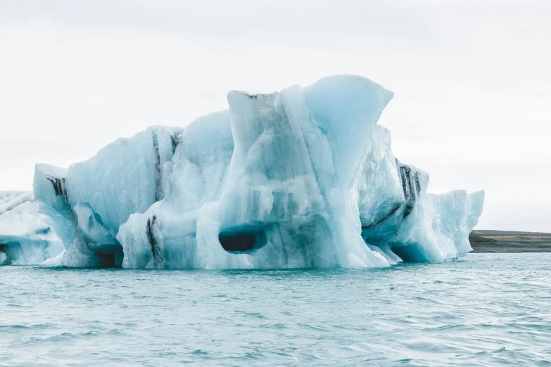 a huge iceberg floating in the middle of water