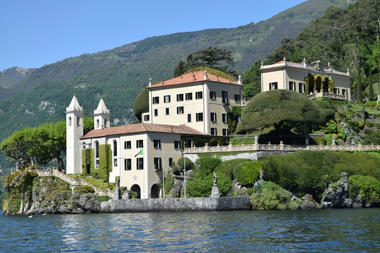 a huge house on the shore of a lake