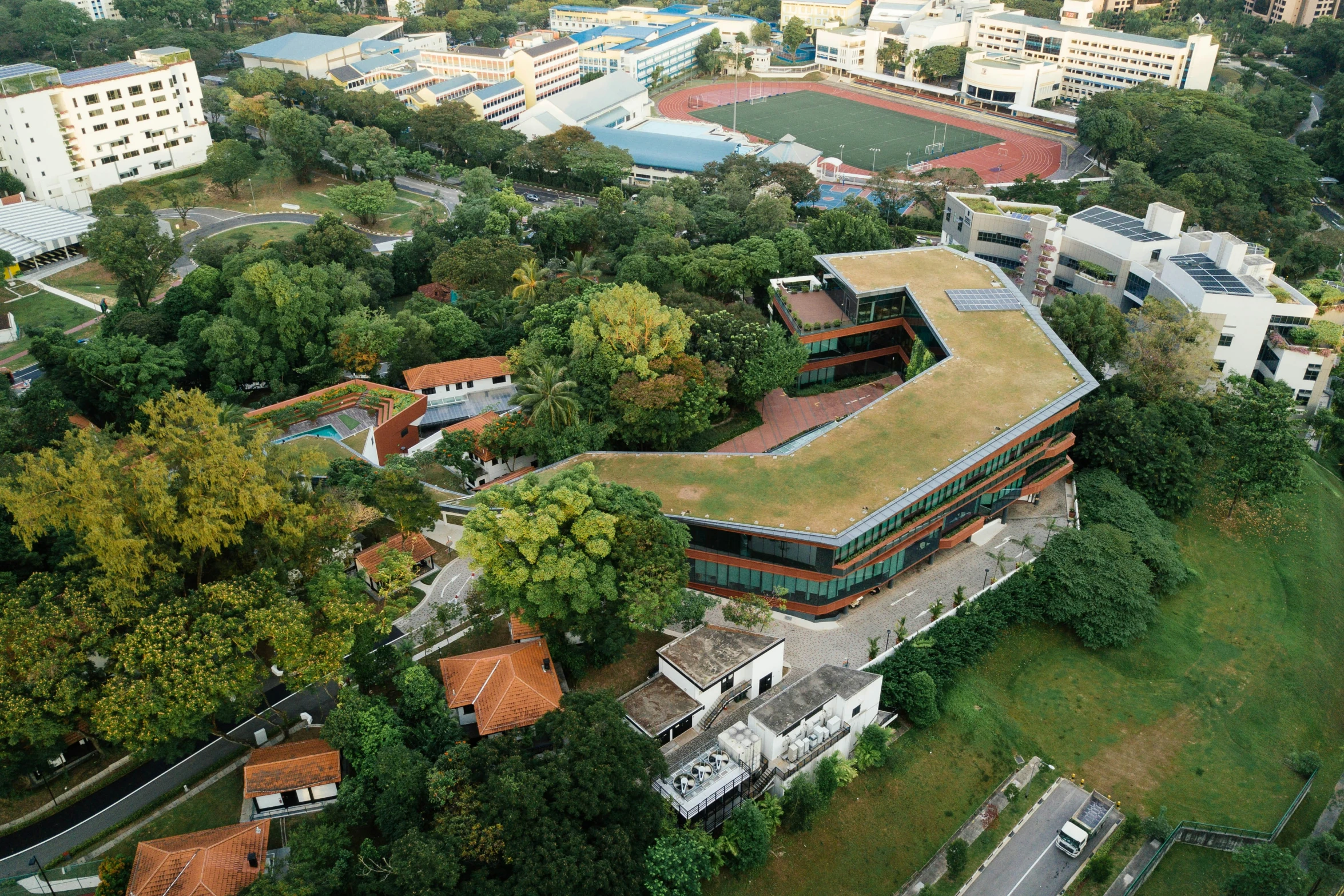 an aerial s of a cam with grass roof and buildings