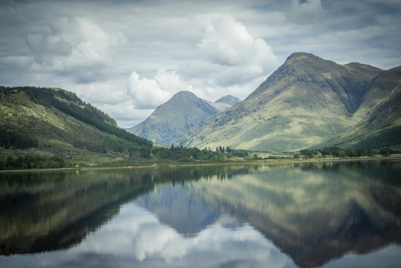 an image of mountains and water taken at a lake