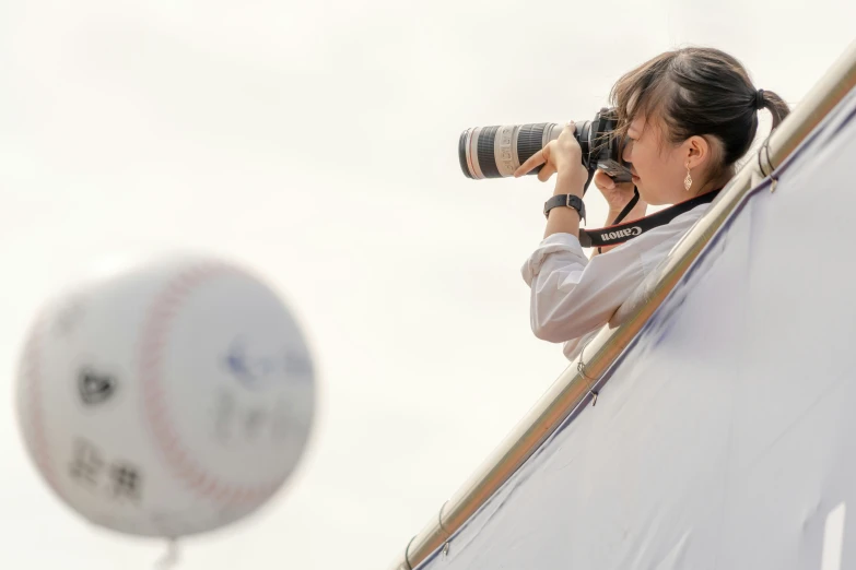 the pographer is taking a picture of a baseball