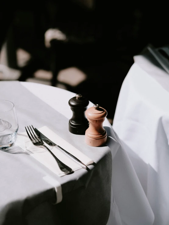 a dining table that has a wooden top and place setting