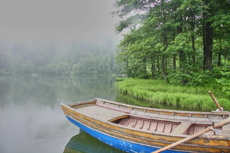 the empty blue canoe is on the lake