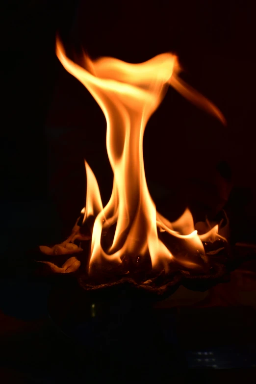 a closeup view of fire and flames on a dark background