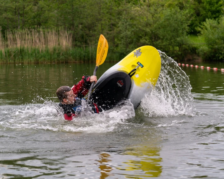 two people are in the water on a kayak