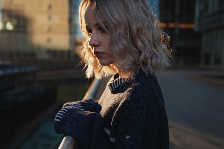 woman leaning on railing looking back at camera