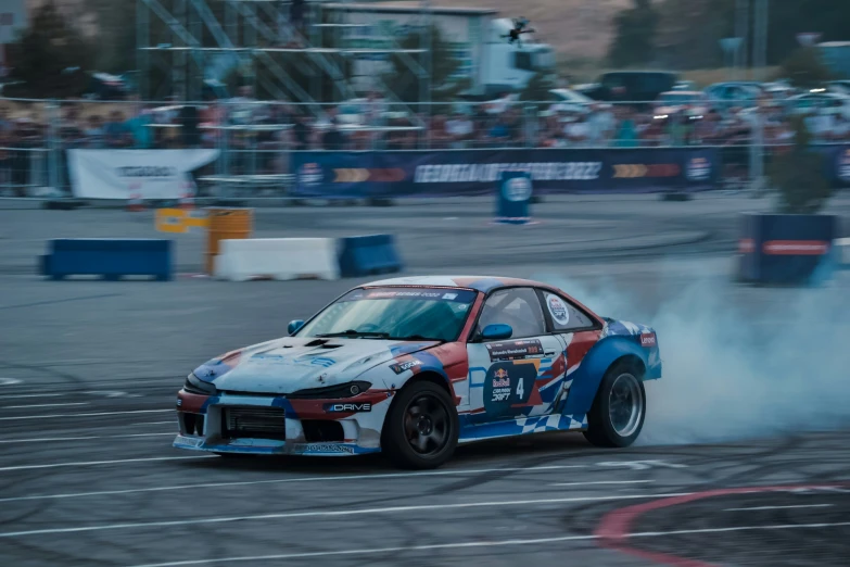 a car on the track with smoke coming out of its exhaust system