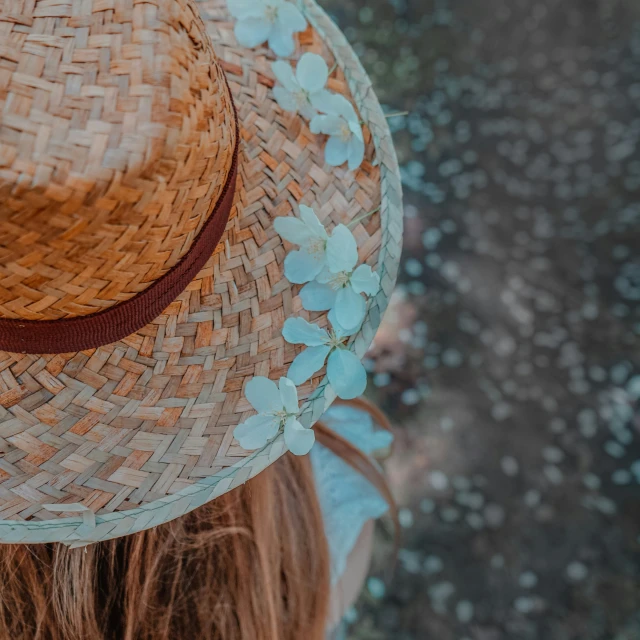 the back of a hat has flowers painted on it