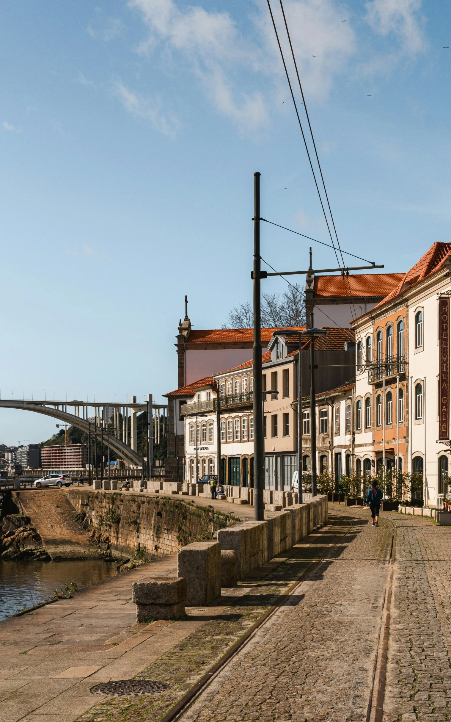 some buildings are lined on the edge of a cobblestone road