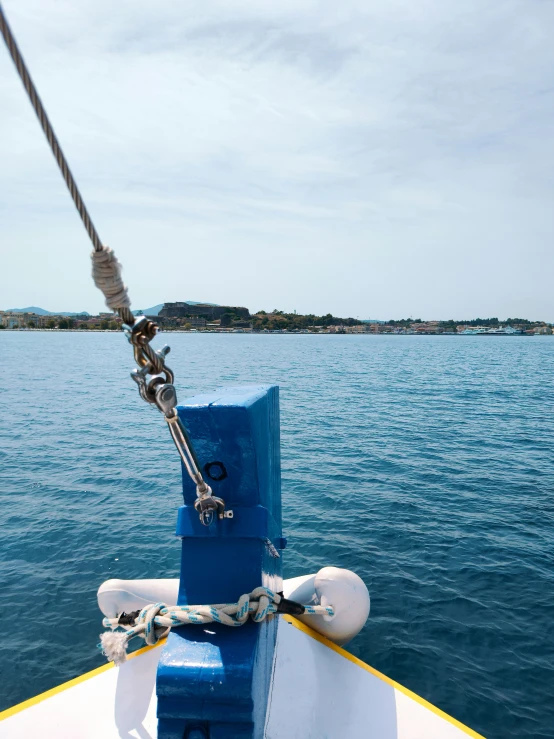 boat tied up to a blue and white object on the water