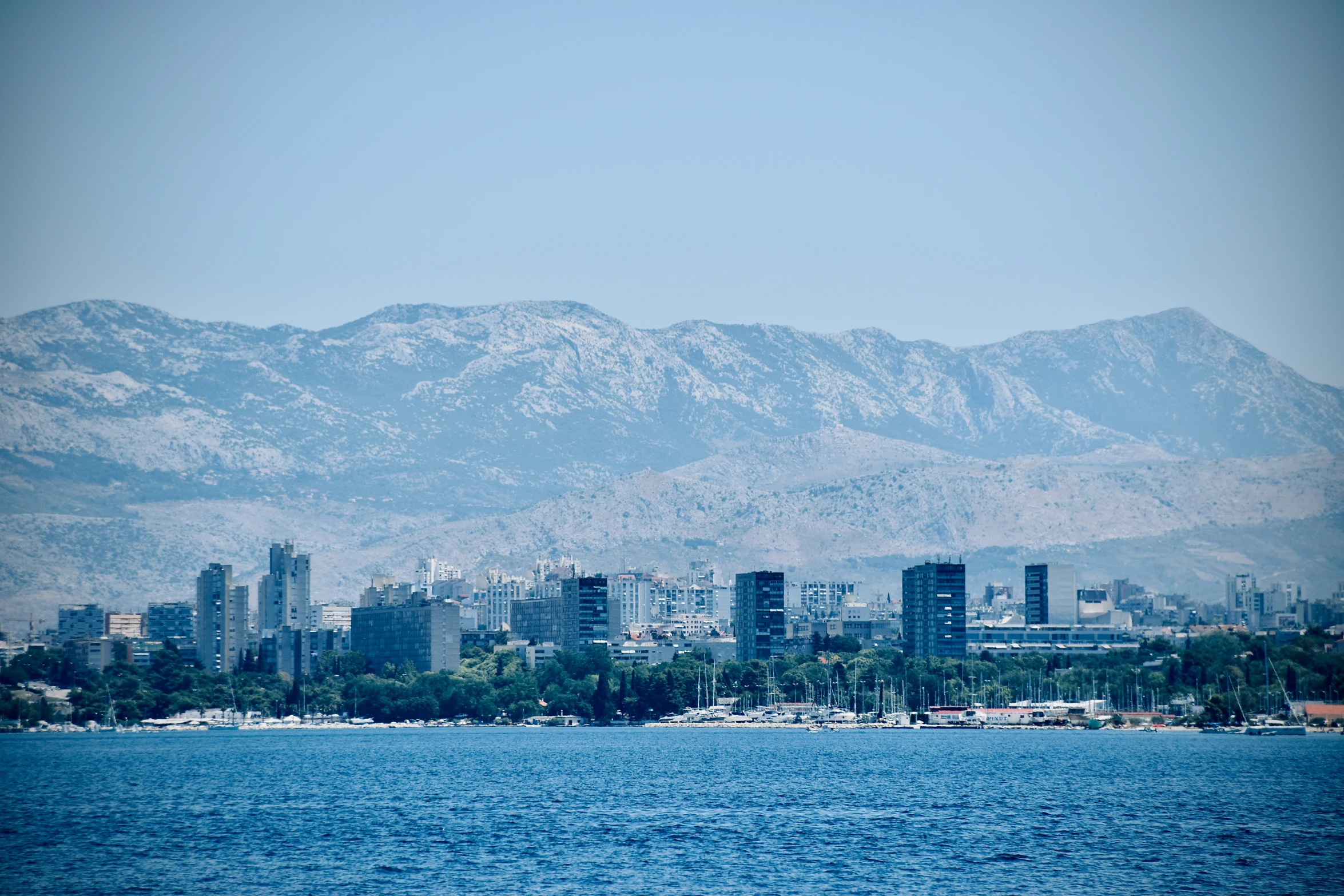 a very big pretty city by some big mountains