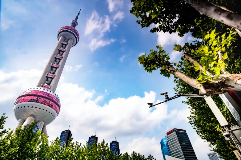 the oriental style tower stands next to a park