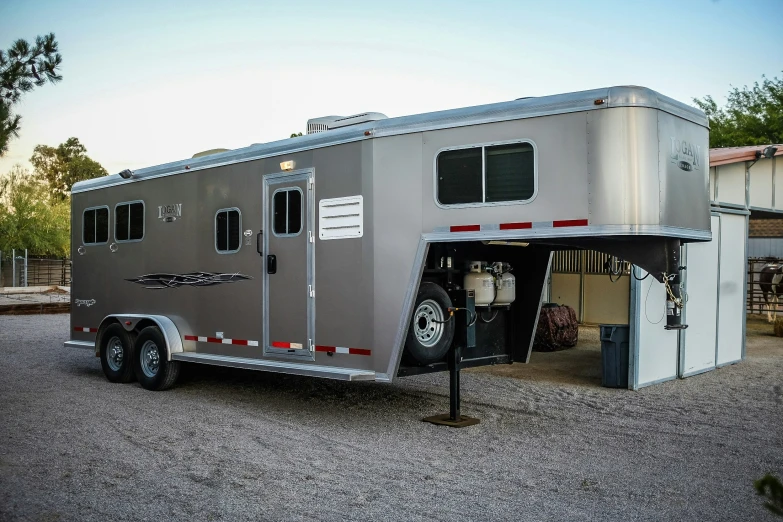 horse trailer parked in driveway with its doors open
