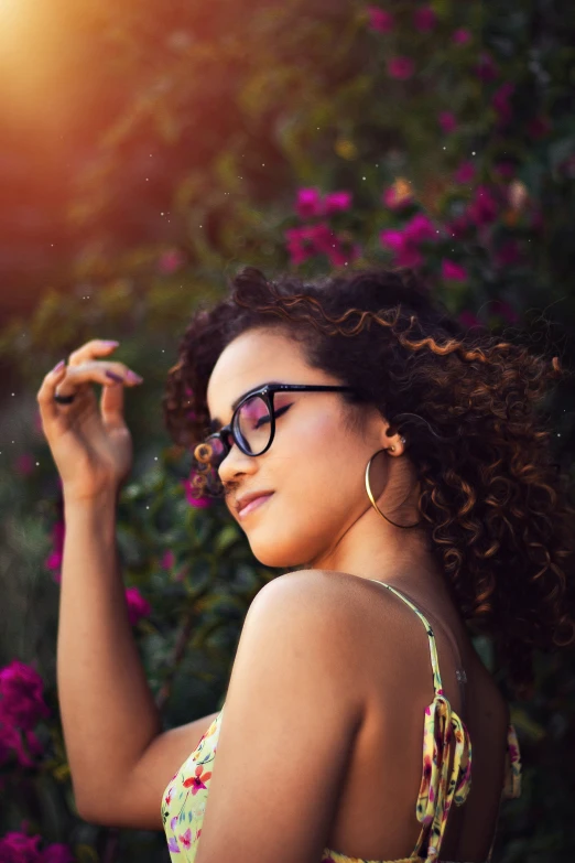 a woman in sunglasses is looking at the sun