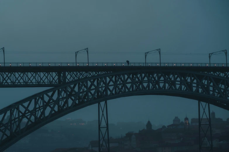 a bridge over water with a train moving across it