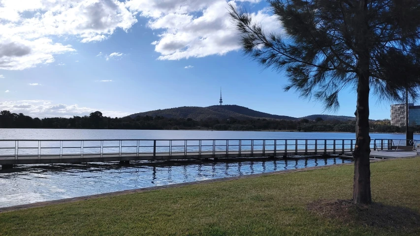 a body of water sitting next to a lush green park