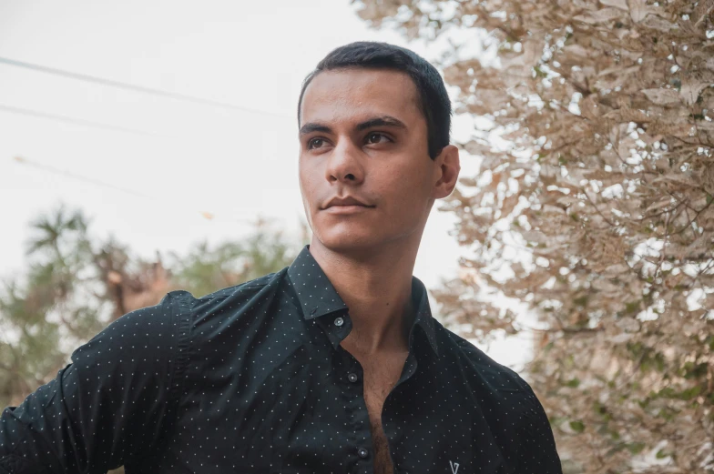 a man in a green shirt poses for the camera