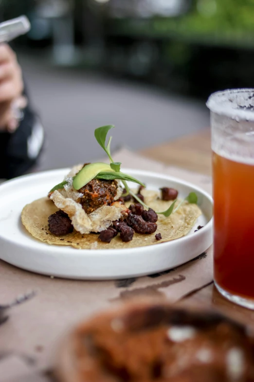 a white plate topped with food next to a cup of drink