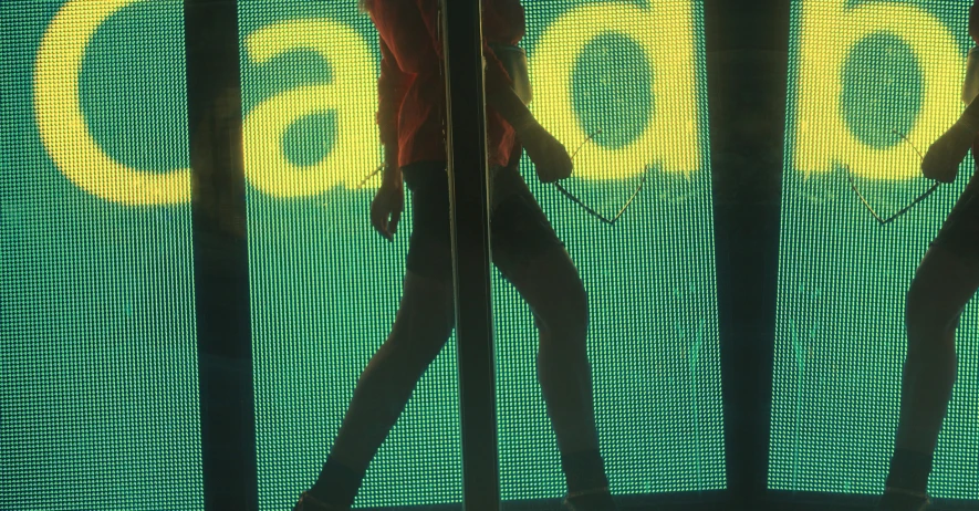 a pair of woman dancers in front of a billboard