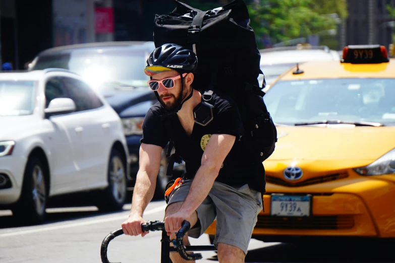 a man on a bicycle talking on his cell phone