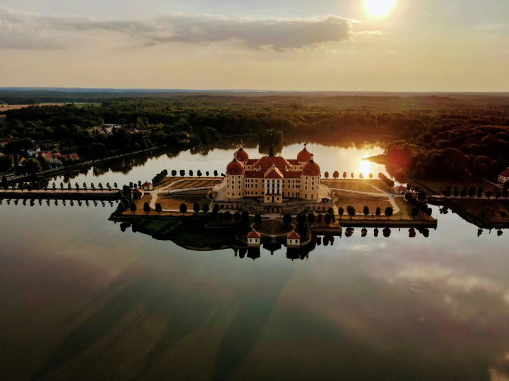 an estate by the water during sunset